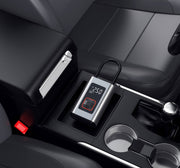 Digital tire inflator with LED display placed in a car console, showcasing a modern and compact design.