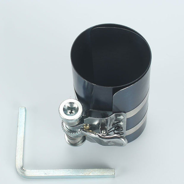 Piston ring compressor tool with adjustable clamp for engine assembly and secure piston installation.