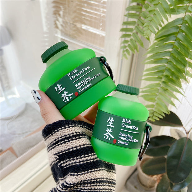 Two green tea drink bottles with labels, held by a person in a striped sweater, showcasing a playful design.