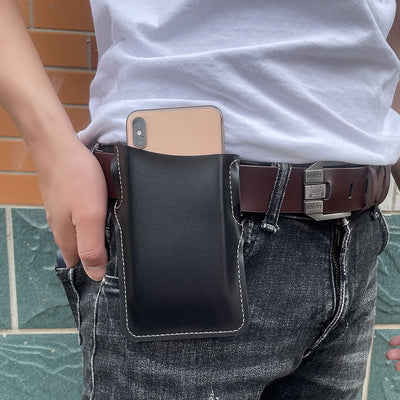 Man wearing a black PU waist bag on his belt, holding a smartphone, showcasing an outdoor fashion accessory.
