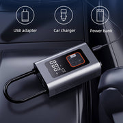 Portable tire inflator with USB adapter, car charger, and power bank functionality on a car dashboard.