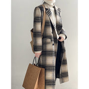 Model wearing a plaid retro double-faced woolen coat, paired with a turtleneck sweater and carrying a bag.