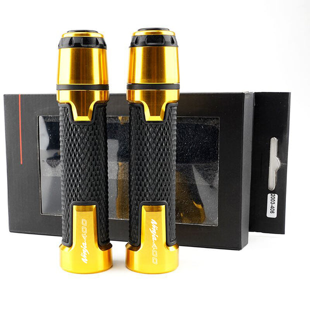 Set of two gold and black motorcycle silicone handle covers in packaging for grip enhancement.