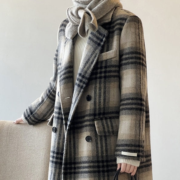 Stylish woman wearing a retro plaid double-faced woolen coat, showcasing its long sleeves and pocket design.