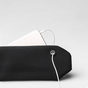 Close-up of a black multifunctional sports waist bag with a phone and charging cable.