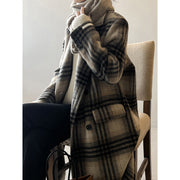 Model wearing a plaid double-faced woolen coat with long sleeves, showcasing a stylish retro look.